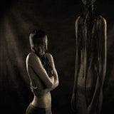 Two figures in a dark, moody setting with one figure partially obscured by hair.