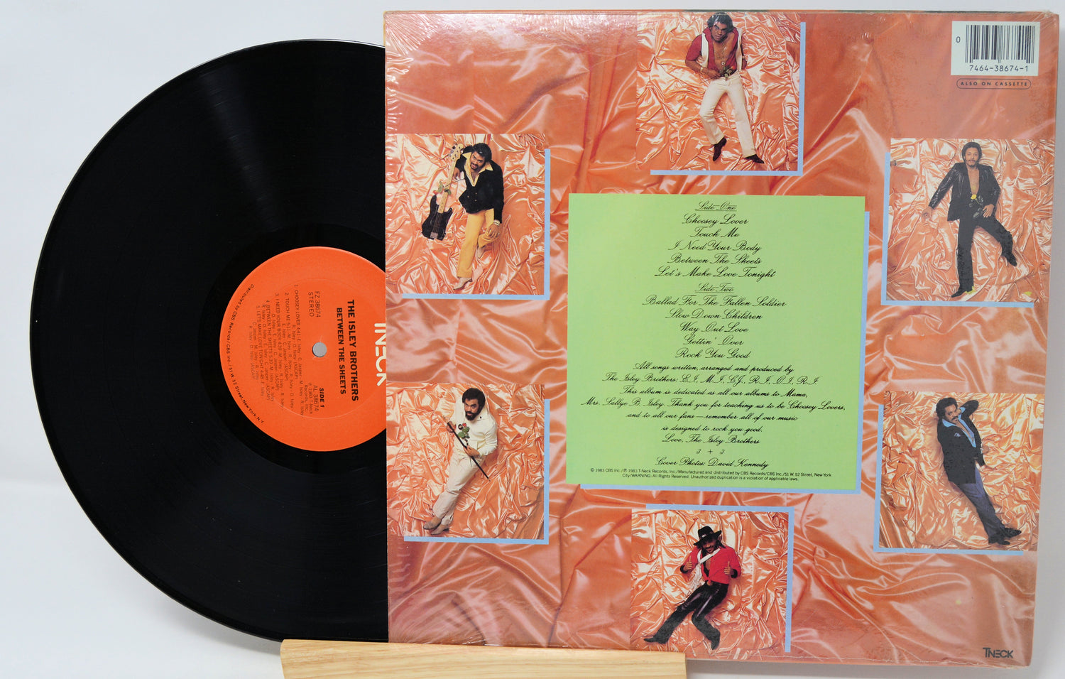 Vinyl record with a colorful cover featuring images of a person and text.