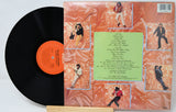 Vinyl record with a colorful cover featuring images of a person and text.
