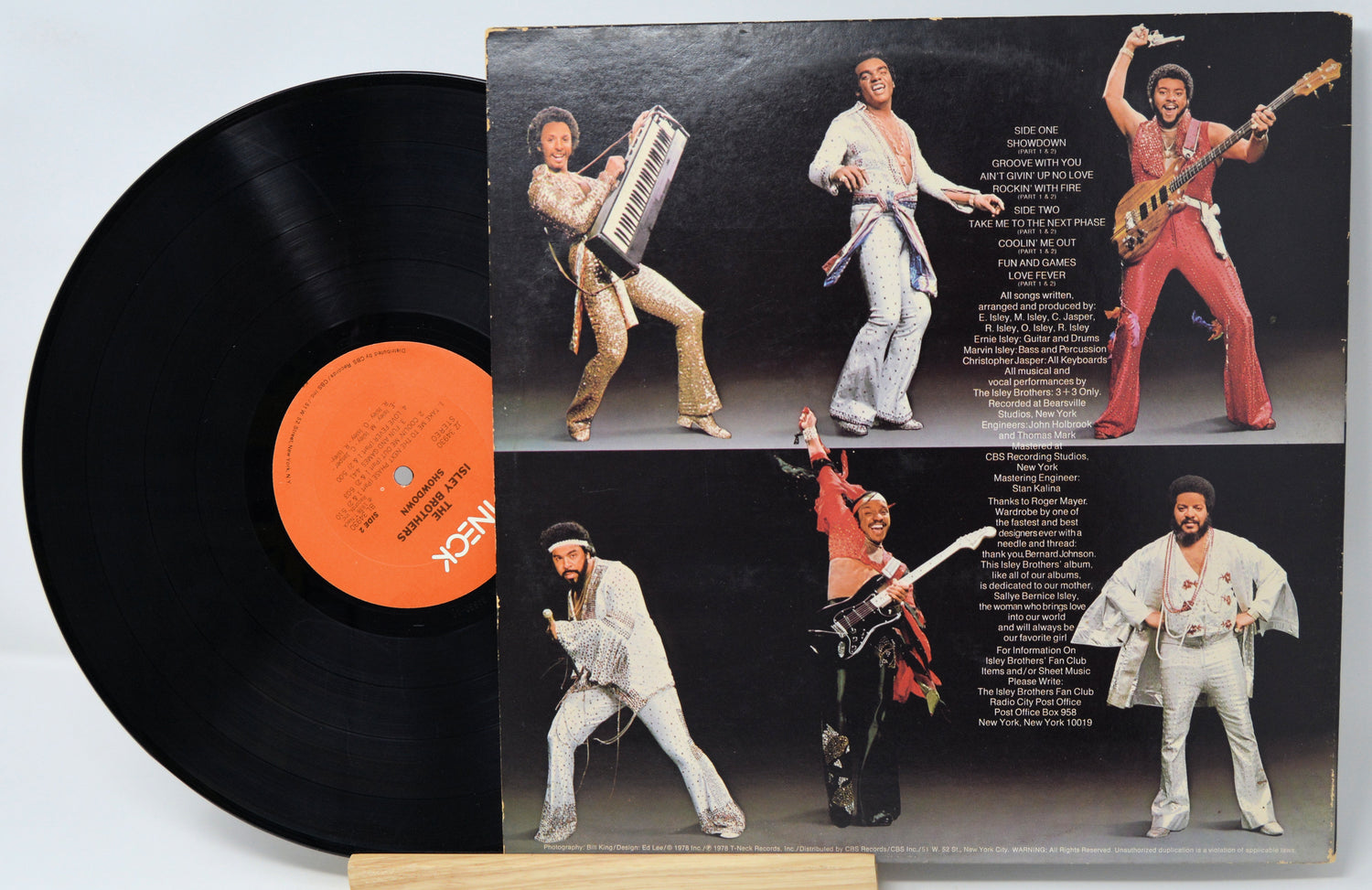 Vinyl record with a colorful cover featuring a band in various poses.
