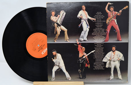 Vinyl record with a colorful cover featuring a band in various poses.