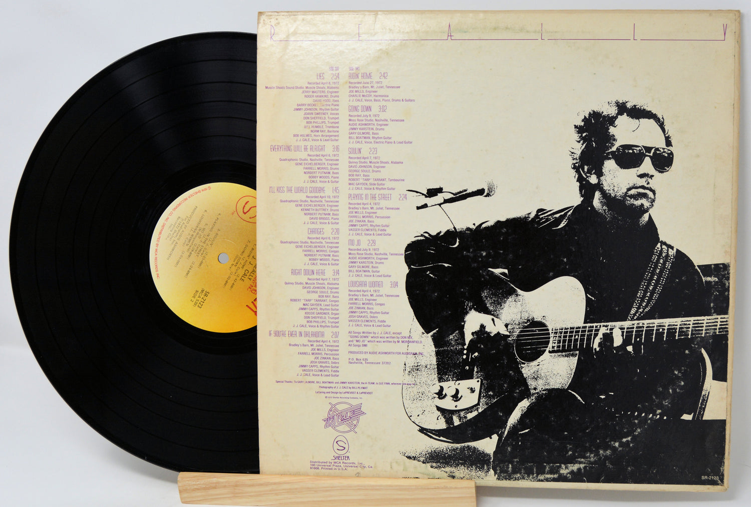 Vinyl record with cover featuring a silhouette of a person playing guitar