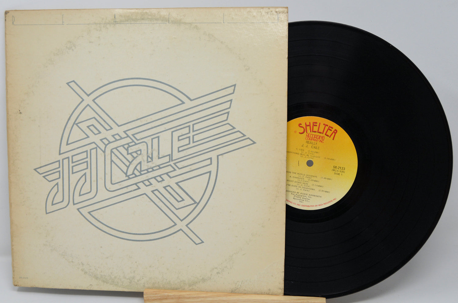 Vinyl record with a yellow label and cover featuring a geometric design.