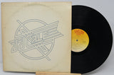 Vinyl record with a yellow label and cover featuring a geometric design.