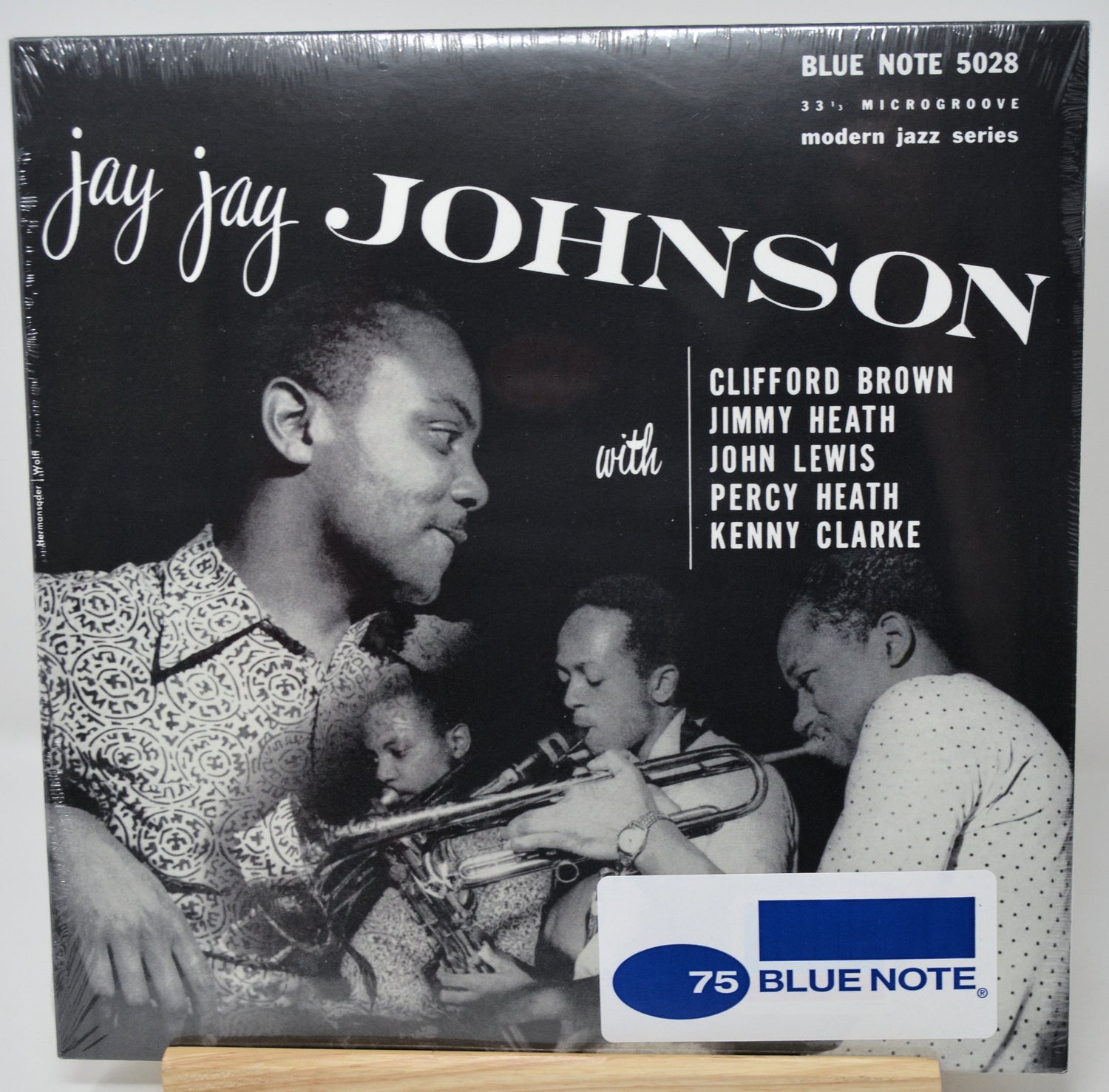 A vintage Blue Note 75 Jazz Series LP record cover for 'Jay Jay Johnson', featuring a black-and-white photo of jazz musicians and the text 'Blue Note 5028'. A white and blue '75 Blue Note' sticker is visible at the bottom.
