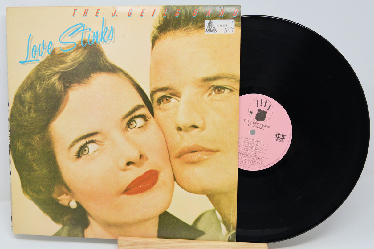 Vinyl record with cover featuring a couple and 'Love Stinks' text