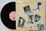 Vinyl record with a colorful cover featuring black and white photos of a person.