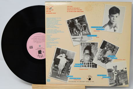 Vinyl record with a colorful cover featuring black and white photos of a person.