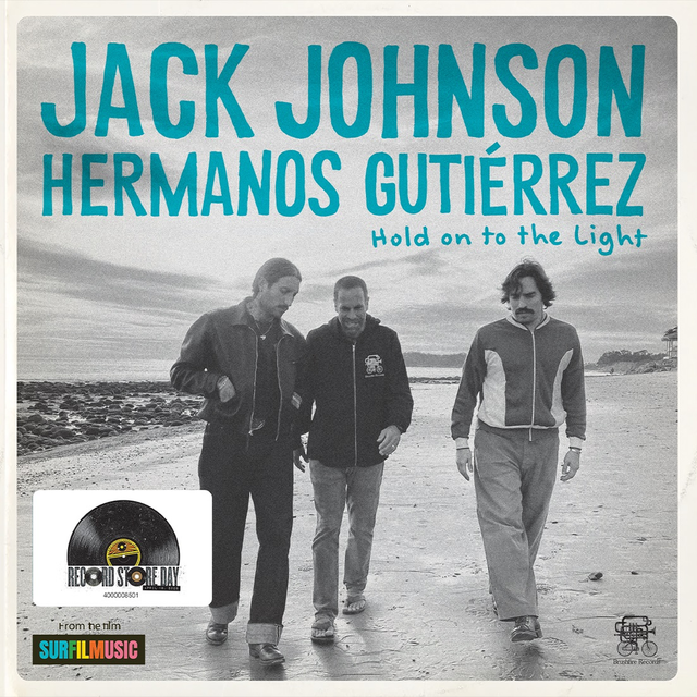 Album cover for 'Hold on to the Light' by Jack Johnson Hermanos Gutierrez with three people walking on a beach.