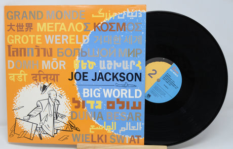 Vinyl record with colorful cover featuring text and a stylized illustration of a person playing drums.