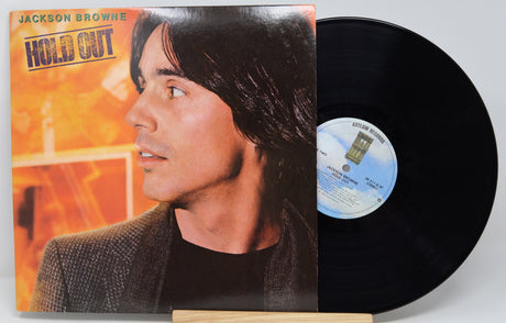 Vinyl record with cover featuring a person's profile and album title 'Hold Out' by Jackson Browne.