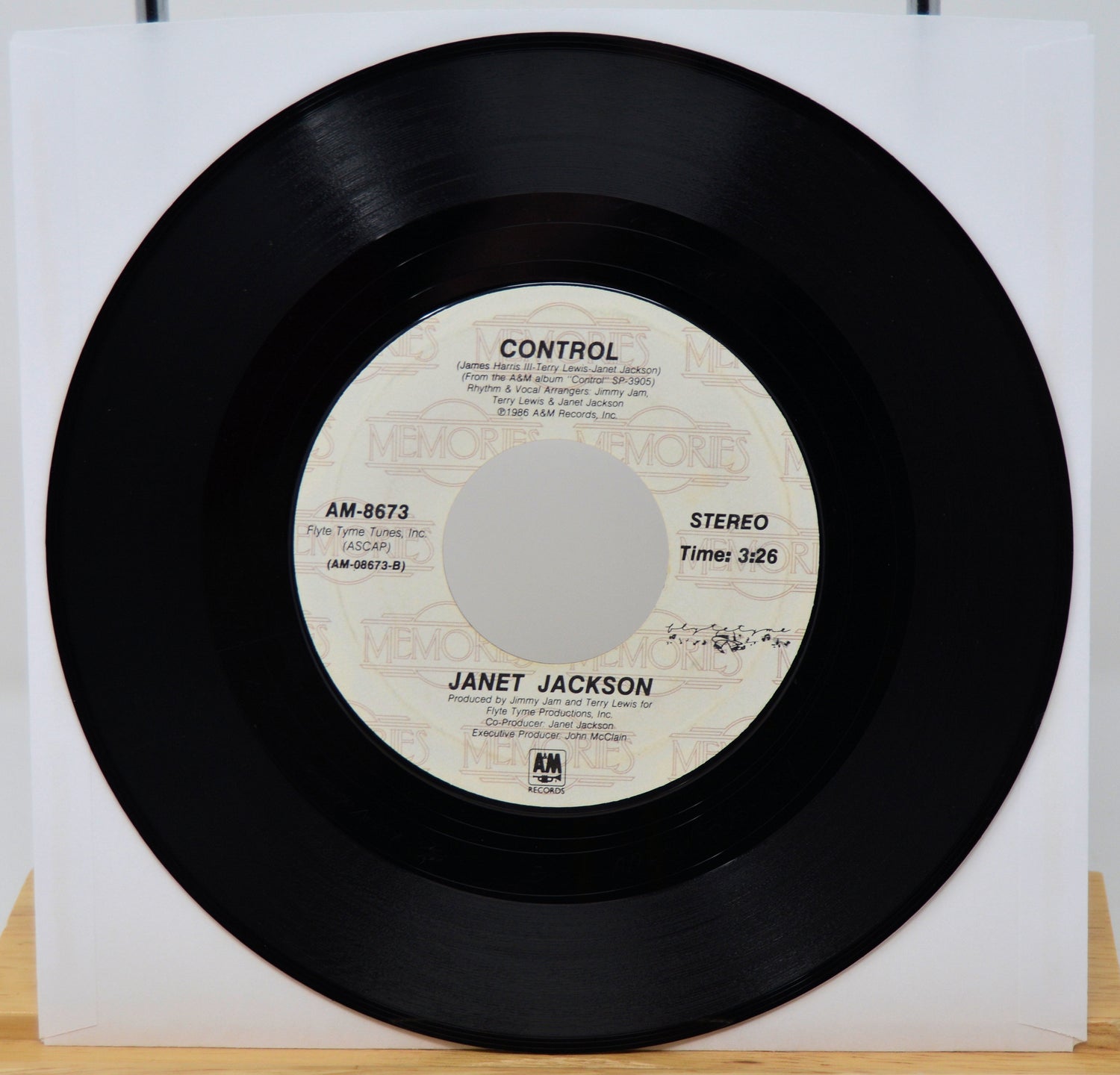 Vinyl record with 'Control' by Janet Jackson on a white background