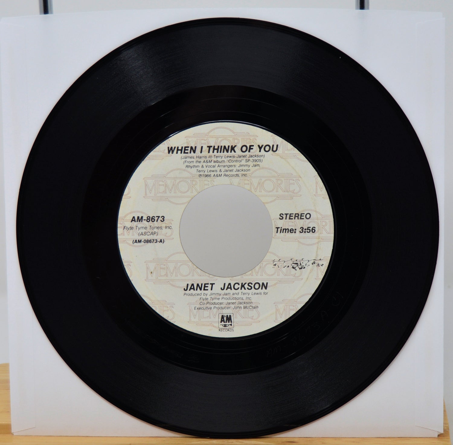 Vinyl record with 'When I Think of You' by Janet Jackson on a white background