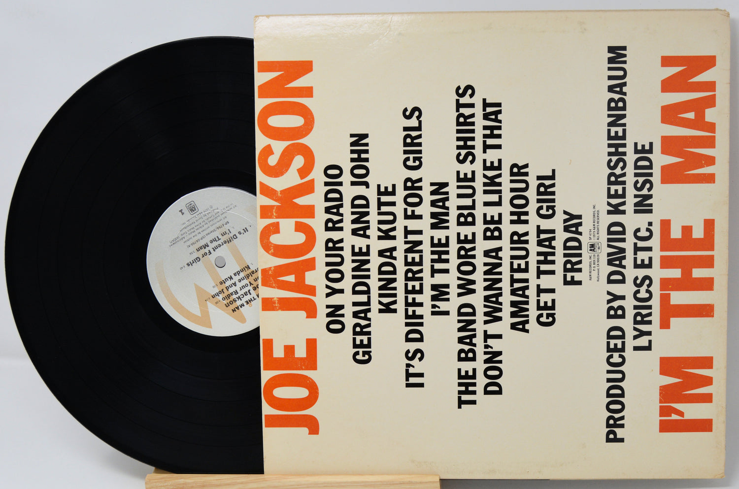 Vinyl record with a cover featuring text and a black record on a white background