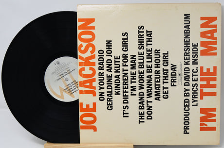 Vinyl record with a cover featuring text and a black record on a white background