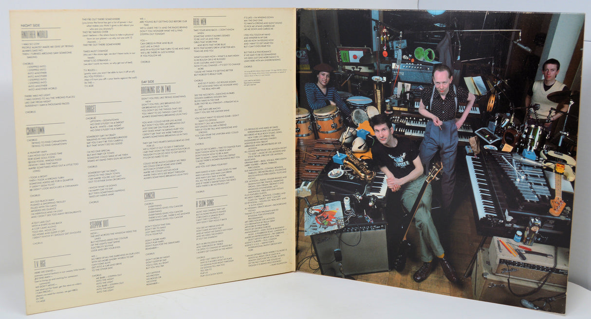 Vinyl record with a cover featuring musicians in a studio setting.