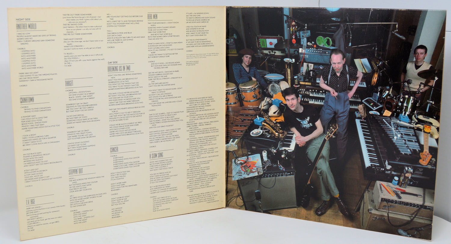 Vinyl record with a cover featuring musicians in a studio setting.
