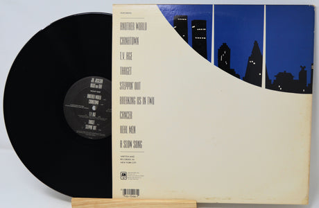 Vinyl record with a cityscape design on the cover