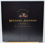 Black album cover with 'Michael Jackson Dangerous' and a face peeking over the top.