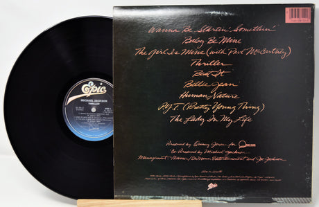 Vinyl record with a black cover featuring text and Epic Records logo.
