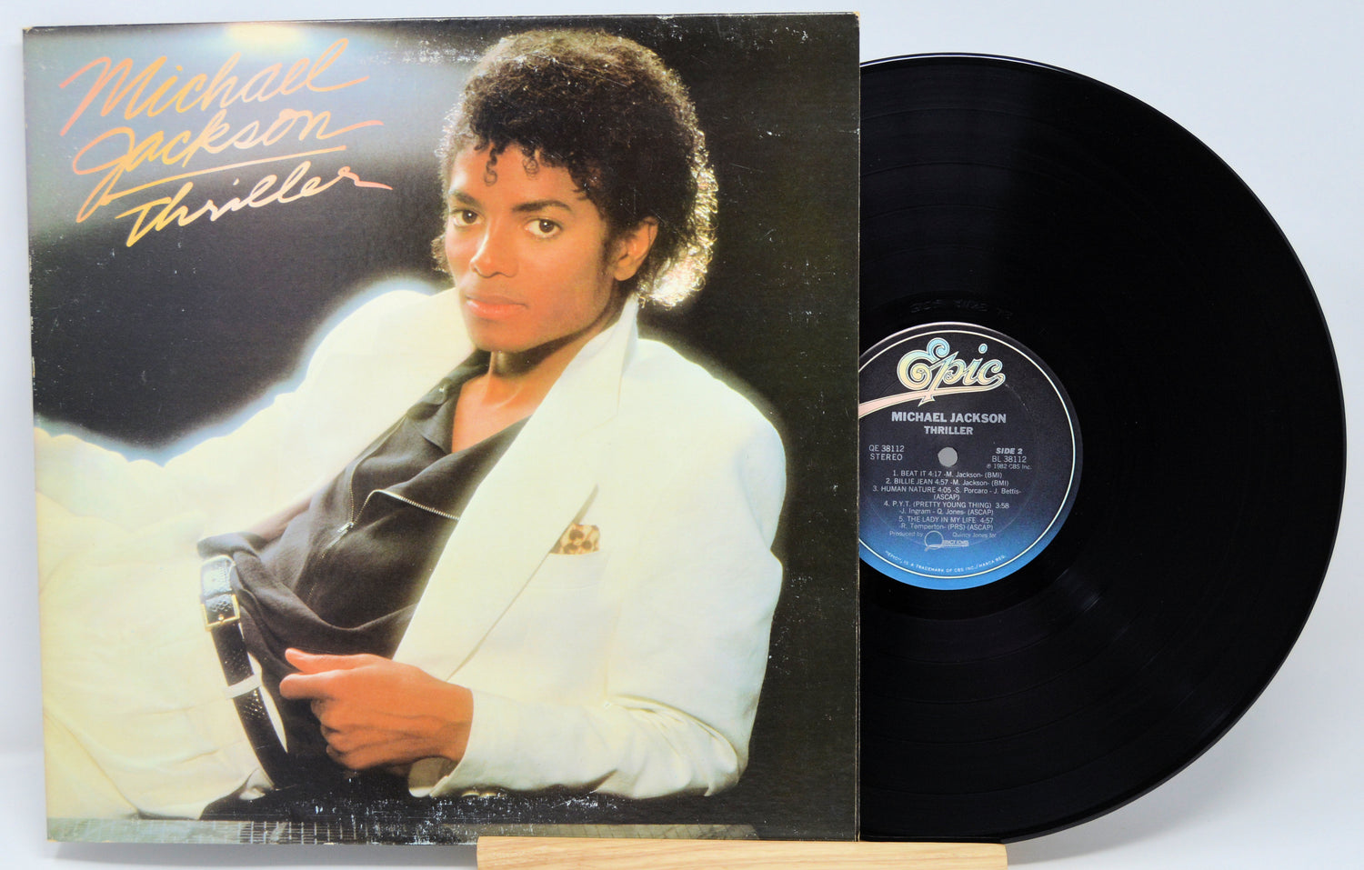 Michael Jackson 'Thriller' album cover and vinyl record on a white background