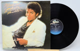 Michael Jackson 'Thriller' album cover and vinyl record on a white background
