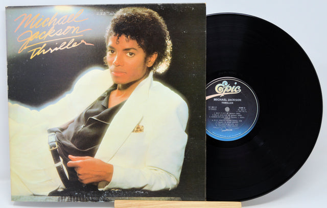 Michael Jackson 'Thriller' album cover and vinyl record on a white background