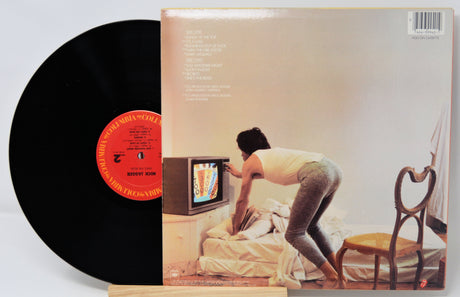 Vinyl record with cover showing a person interacting with a television.
