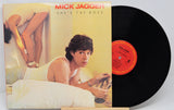 Vinyl record with cover featuring Mick Jagger and text 'She's the Boss'.