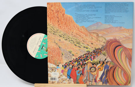 Vinyl record with a colorful album cover depicting a desert scene and people.