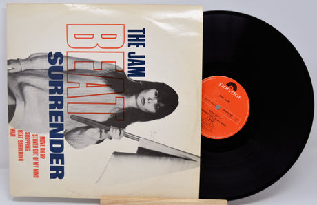 Vinyl record and cover of 'The Jam' album 'Surrender' with 'Beat It' text.