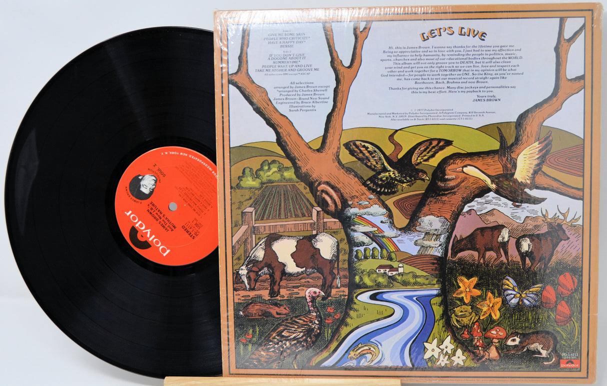 Vinyl record with a colorful cover featuring nature scenes and text.
