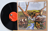 Vinyl record with a colorful cover featuring nature scenes and text.