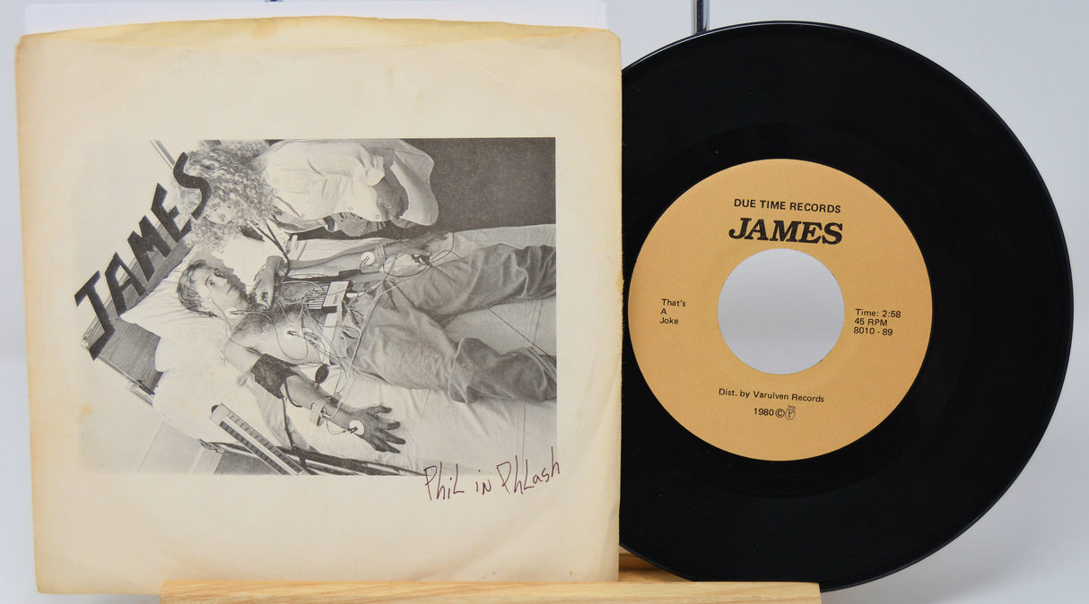Vinyl record with yellow label and cover featuring black and white illustration, on a white background.