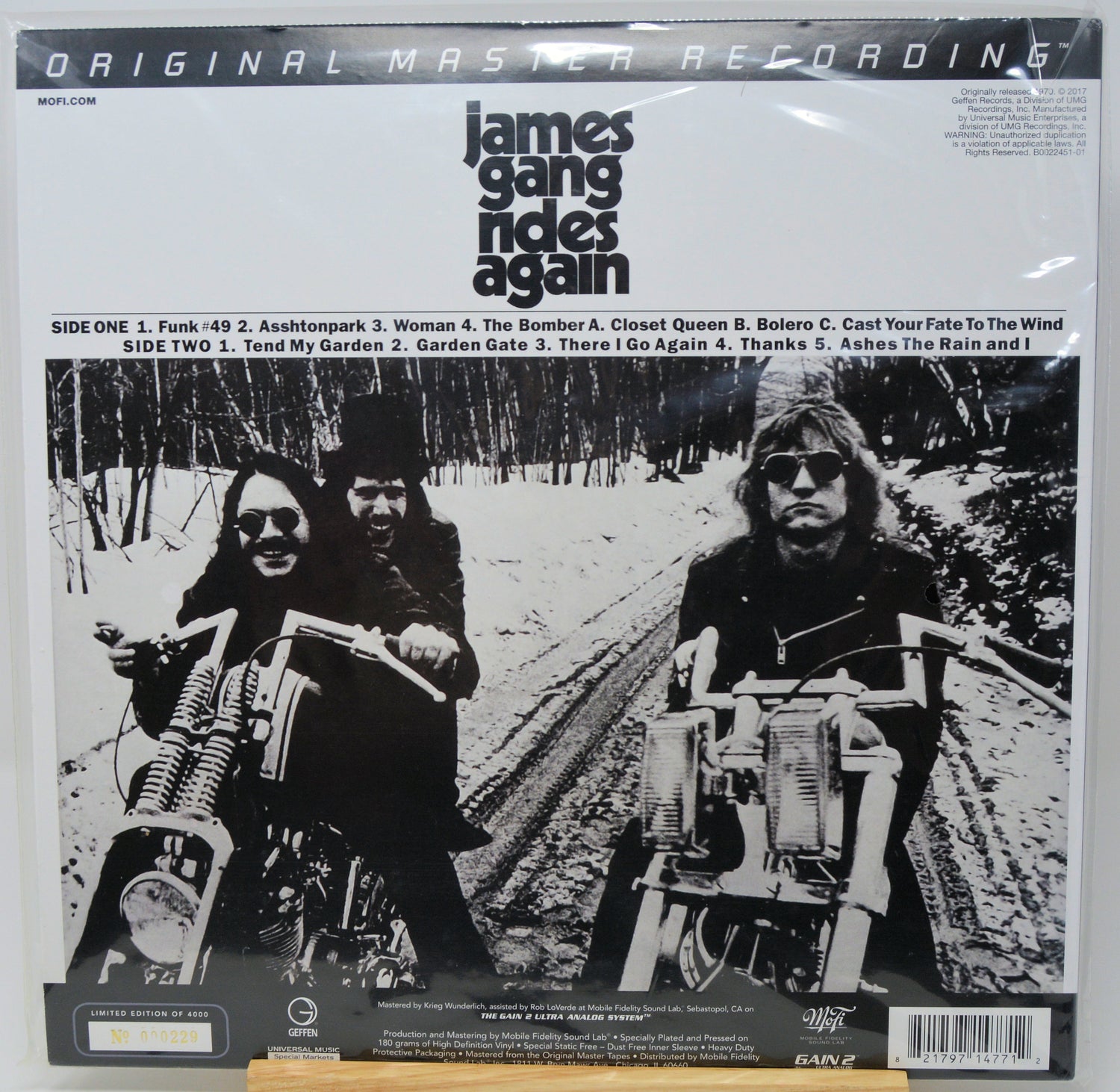 James Gang 'Again' 12-inch vinyl record LP cover, featuring a black and white photo of the band on motorcycles, with track listing and release details printed on the front.