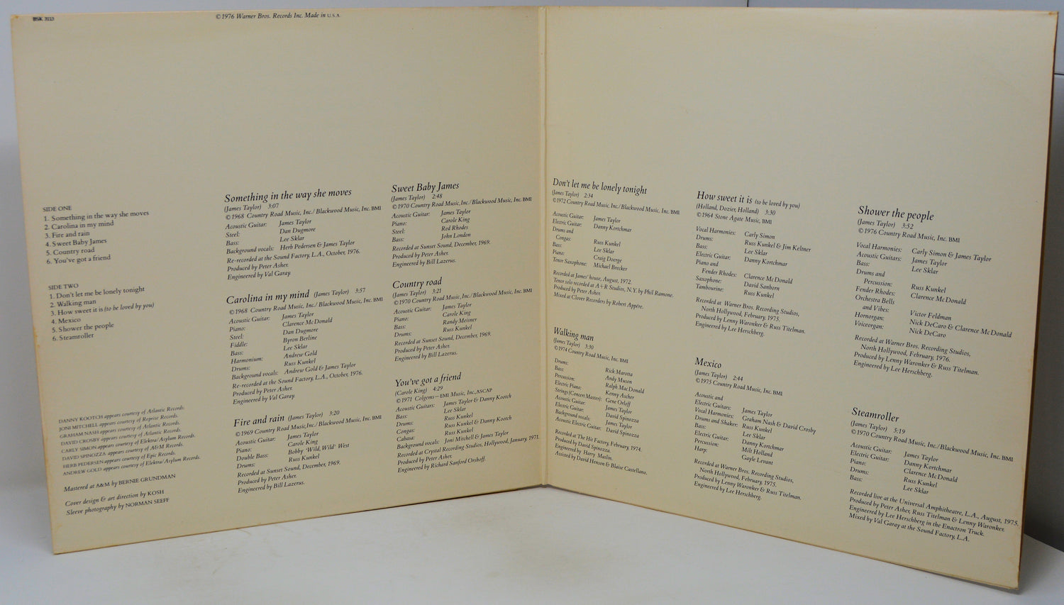An open vintage songbook or printed booklet with cream-colored pages and black printed text, photographed against a light neutral background.