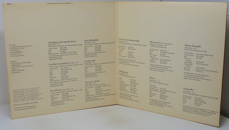 An open vintage songbook or printed booklet with cream-colored pages and black printed text, photographed against a light neutral background.