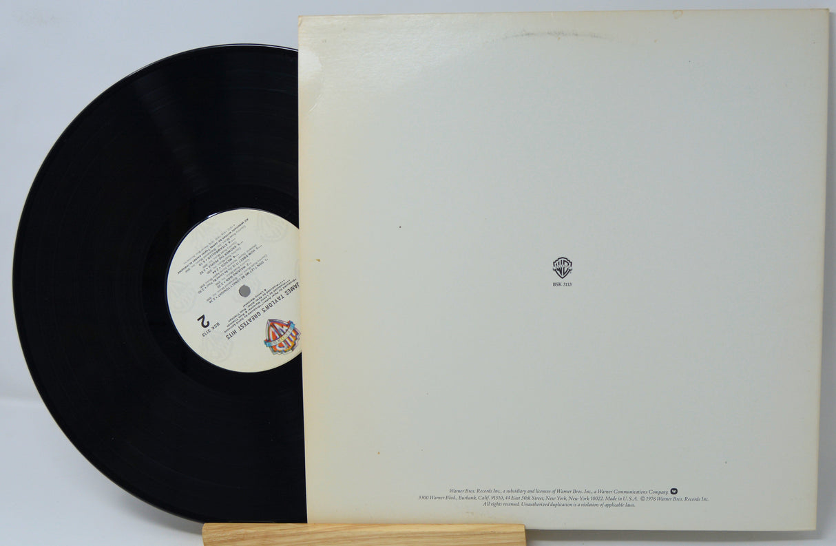 Vinyl record with a white label on a gray background