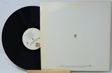 Vinyl record with a white label on a gray background