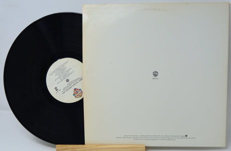 Vinyl record with a white label on a gray background