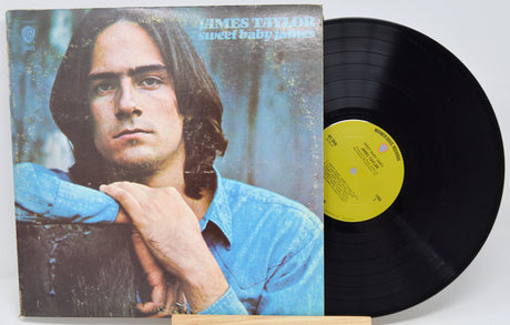 Vinyl record 'James Taylor Sweet Baby James'  with cover featuring a person, on a white background