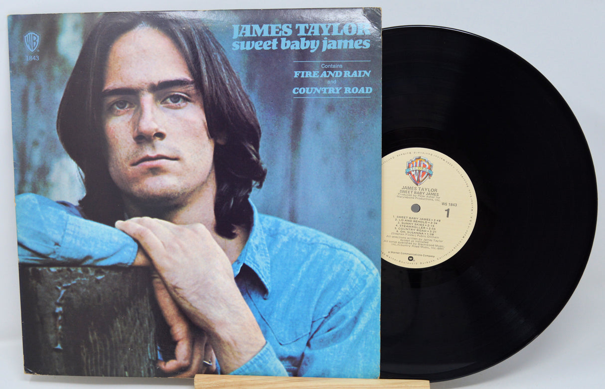 Vinyl record with cover featuring a person, on a light gray background