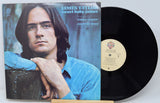 Vinyl record with cover featuring a person, on a light gray background