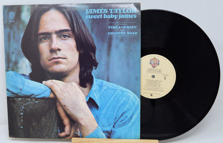 Vinyl record with cover featuring a person, on a light gray background