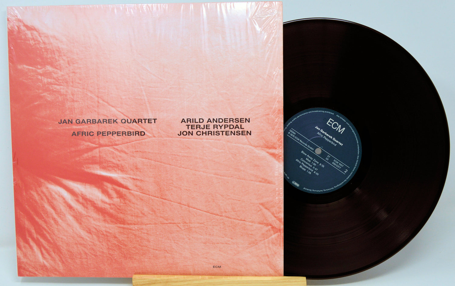 Front cover of Jan Garbarek Quartet Afric Pepperbird vinyl LP featuring minimalist pink design and member names