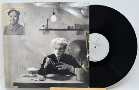Vinyl record with cover featuring a black and white photograph of a person eating.