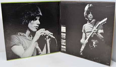 Album cover with black and white photos of a musician playing guitar and another holding a microphone.