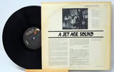 Vinyl record with cover displaying text and a black and white photo on a light blue background