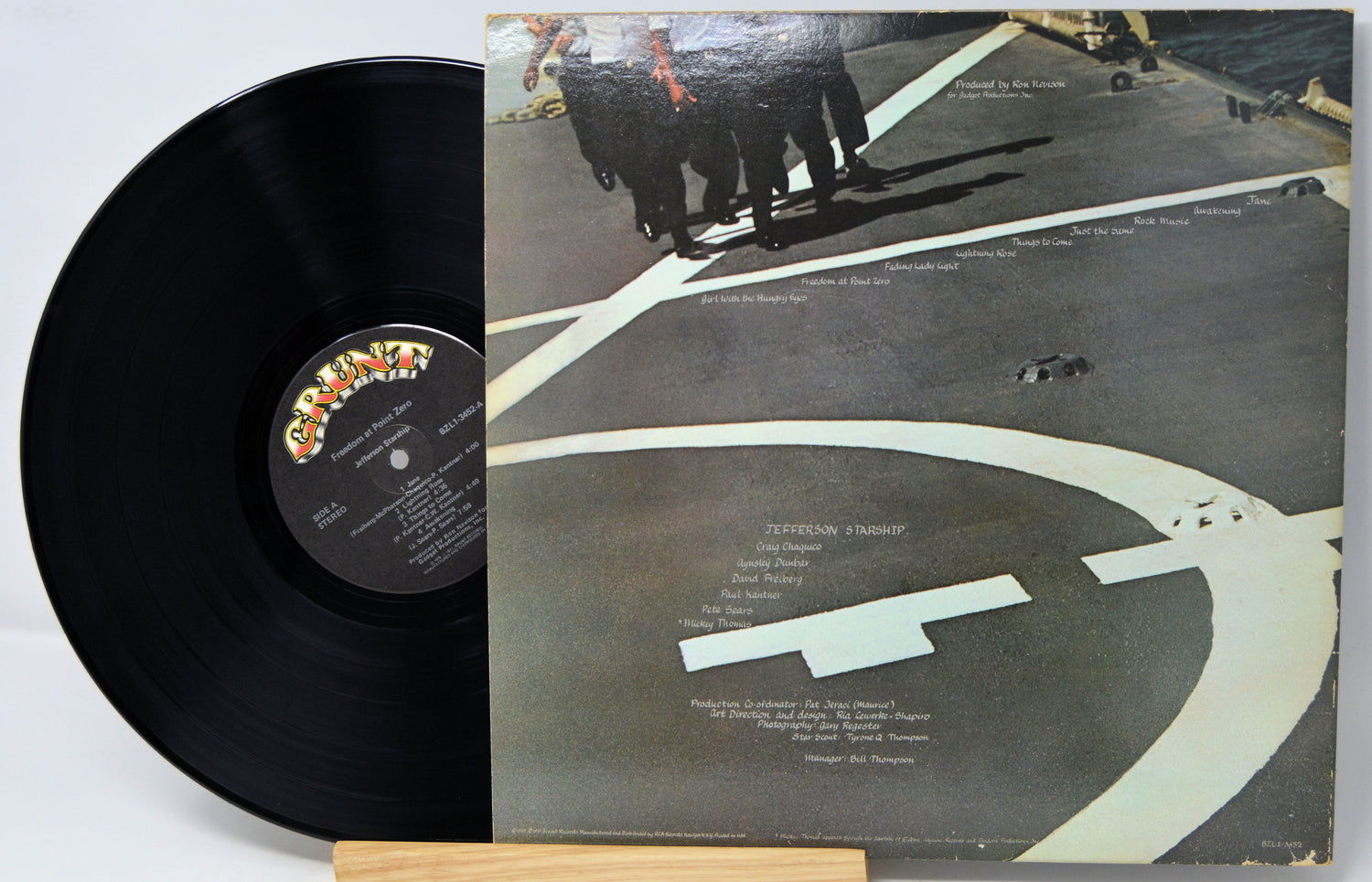 Vinyl record with cover featuring a group of people on a rooftop.