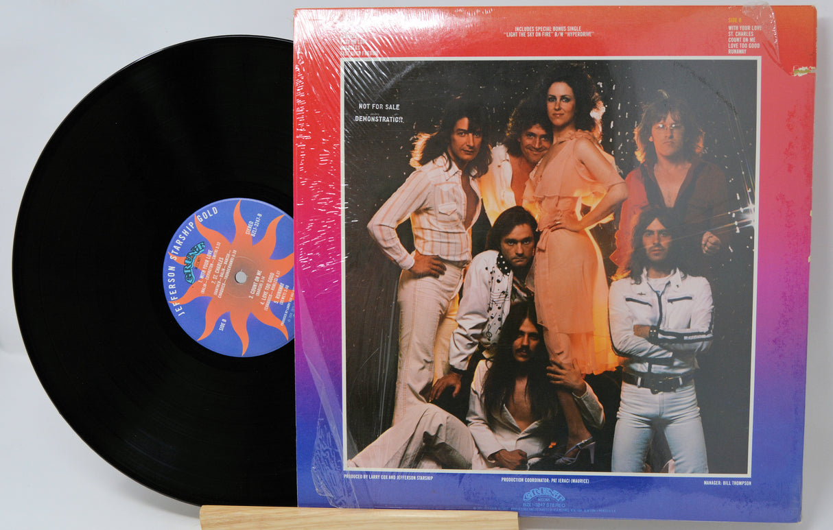 Vinyl record with a colorful cover featuring a group of people.